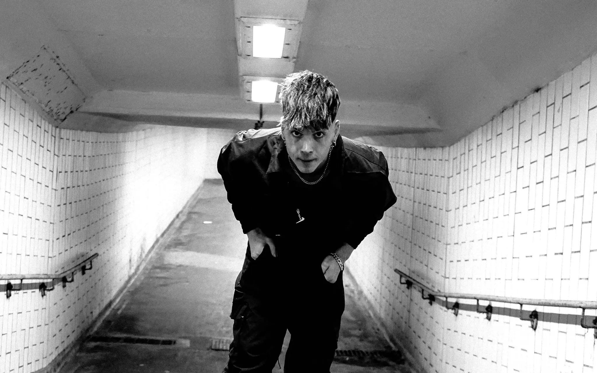 Ren — black-and-white portrait in a tiled stairway